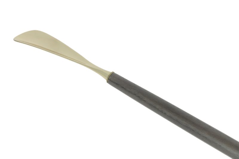 Back-scratcher shoehorns in brass and zinc, and dark ash wood